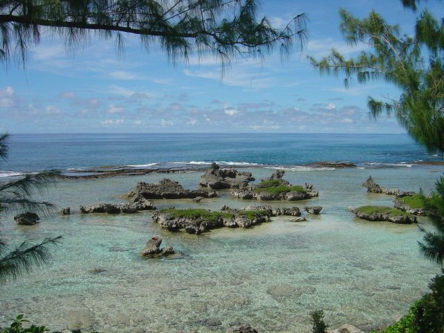 Coral rock islets in the reef flat behind the edge of the reef on Guam. Picture