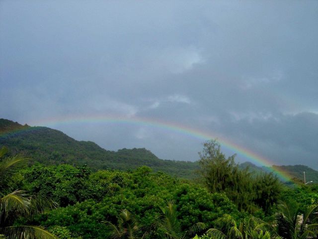A rainbow graces the jungle foliage of the Guam mountains. Picture