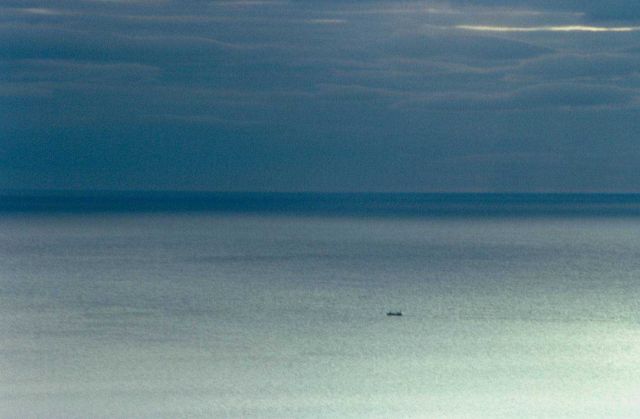 The vastness of the ocean becomes apparent in this image of a seemingly small ship plying its way from endless horizon to endless horizon. Picture