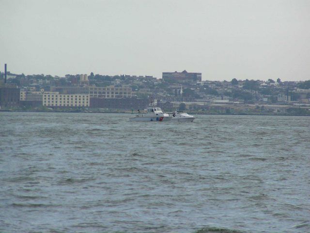 Coast Guard patrol craft inspecting pleasure craft in New York Harbor area. Picture