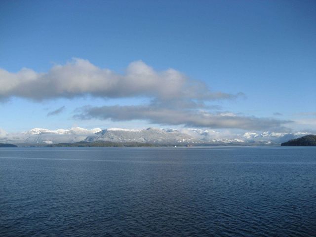 Mountains, snow, and tug and tow along the Inside Passage. Picture