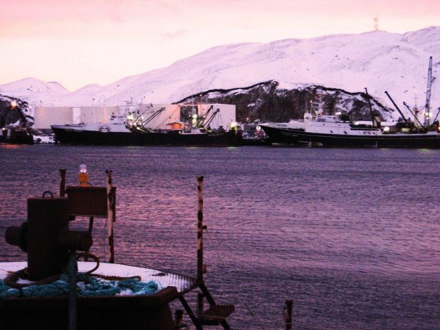 Large fishing vessels tied up at fuel facility. Picture