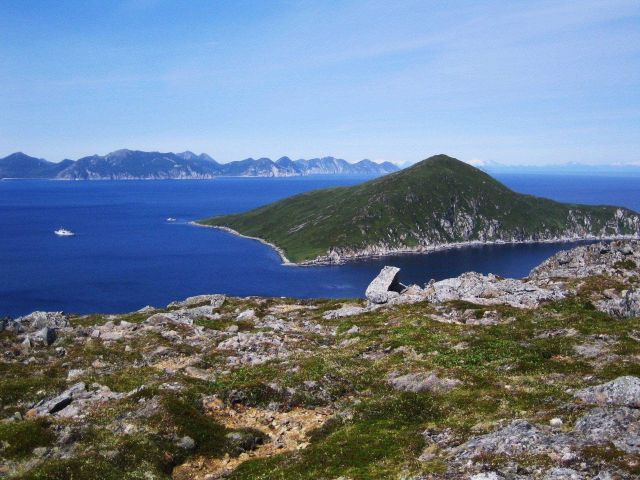 The view from the top of Little Koniuji Island looking across the Shumagins towards the snow-covered peaks of the Alaska Peninsula Picture