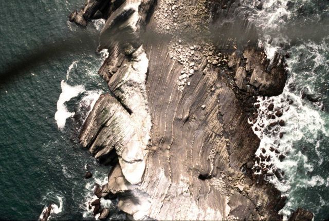 Tilted twisted beds on San Pedro Rock bear evidence to the tortured tectonic history of coastal California. Picture