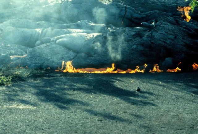 Lava encroaching on a highway and setting the oil in the asphalt on fire. Picture
