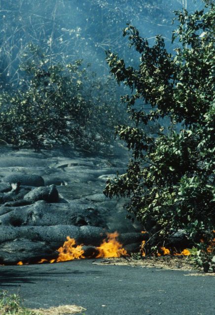Lava encroaching on a highway and setting the oil in the asphalt on fire. Picture