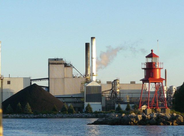 Navigation light at industrial facility harbor area. Picture