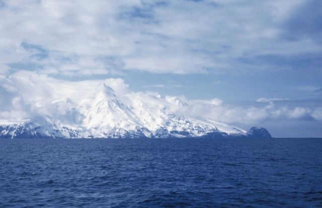 Snow-covered Aleutian volcano seen from offshore. Picture