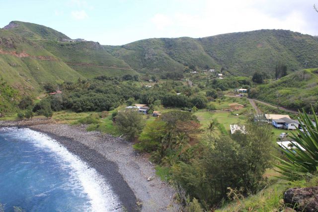 A rural settlement along the Maui coast with a cobble beach lining a quiet cove. Picture