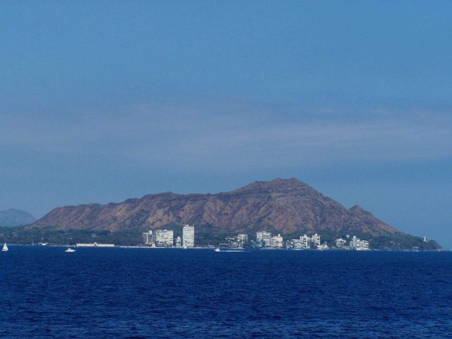 Diamondhead seen from offshore with Diamondhead Light at the right at the base of the mountain. Picture
