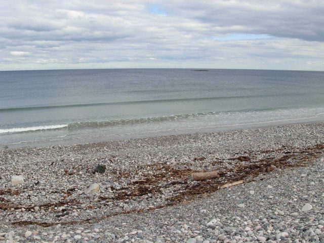 The storm surge and surf protection wall composed of cobbles at Scituate. Picture