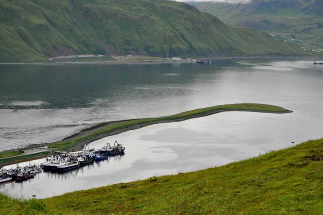 A man-made spit forming a harbor for numerous fishing vessels. Picture