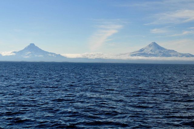 Shishaldin Volcano on the right and Isanotski Volcano on the left as seen from the Bering Sea side of the Aleutian Islands. Picture