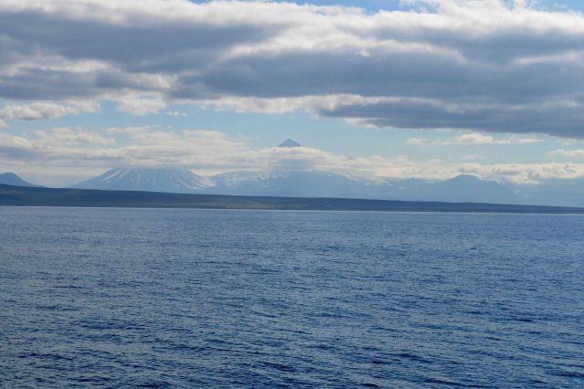 Pavlof Volcano the high peak in the center and Pavlof Sister in center left as seen from the Bering Sea. Picture