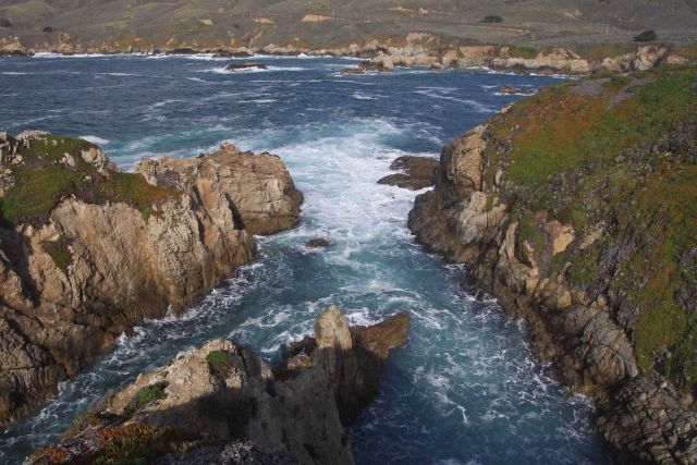 Rocky canyons opening to the sea eroded by the incessant action waves pounding against seemingly, but not, indestructible granite Picture