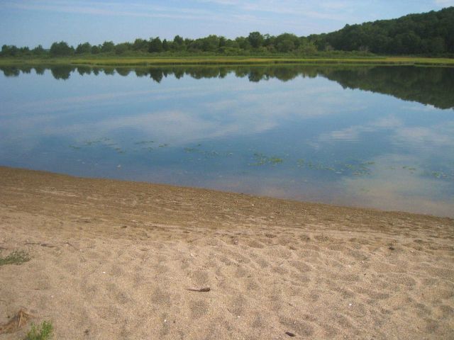 A lagoon and wetlands behind the gravel and shell spit at Bluff Point State Park . Picture