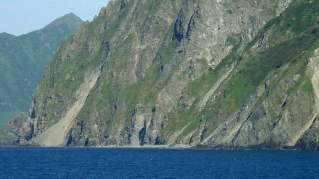 The bold and stunning cliffs of Kodiak Island rising straight out of the sea. Picture