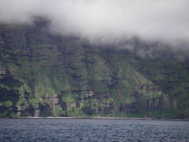 Layer upon layer of volcanic flows formed this cliff on Unimak Island. Picture