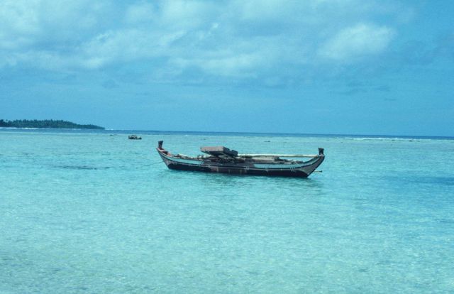 A native outrigger anchored inside the reef line of a Caroline island. Picture