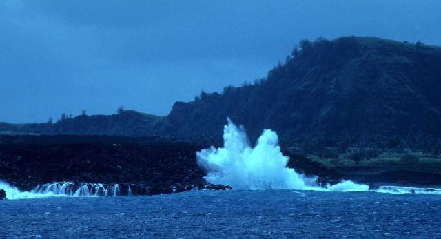 Surf crashing on the volcanic shores of Pagan Island. Picture