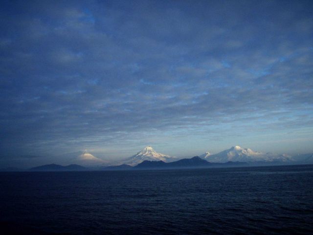 Shishaldin, Isanotski, and Roundtop Volcanoes seen from the Pacific side of Unimak Island. Picture