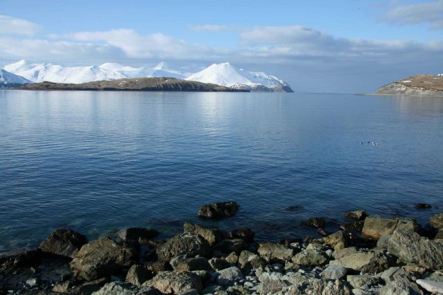 A view of the end of the Dutch Harbor airport runway to the right and volcanic Aleutian peaks to the left. Picture