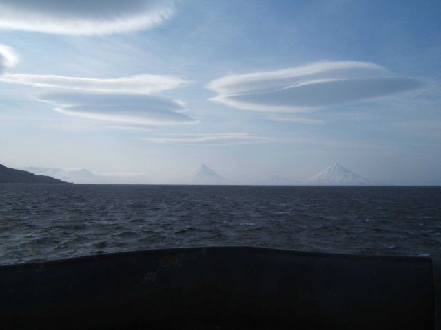 Lenticular clouds seen over the Islands of the Four Mountains. Picture
