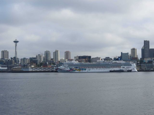 Seattle Space Needle and a large cruise ship, the NORWEGIAN JEWEL, on the Seattle waterfront. Picture
