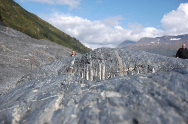 Metamorphic rock with glacial striations angled at about 30 degrees to the layering of the rock. Picture