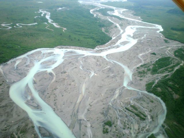 Braided stream with milky sediment laden waters debouching from Hallo Glacier Lake and headed to Shelikof Strait. Picture
