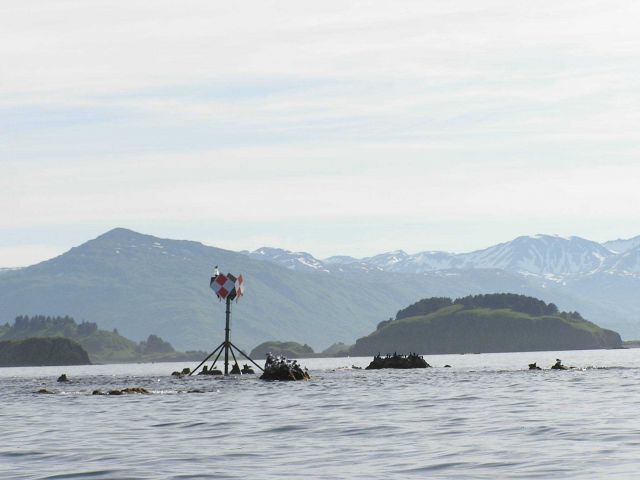 Red and white checked navigation aid warning mariners of baring rocks. Picture