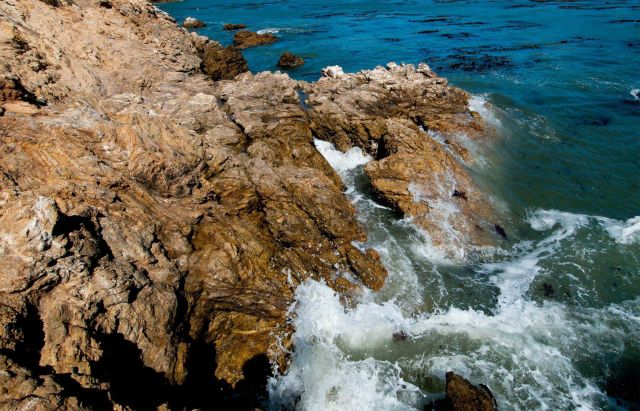 Ocean Water crashing against rocks on the shore. Picture