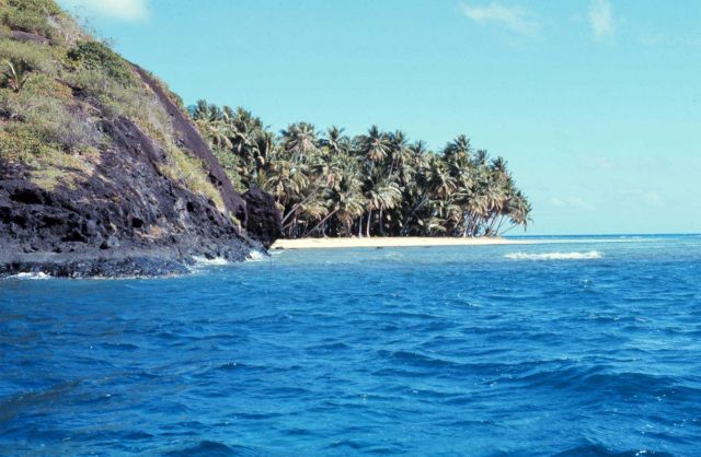 Coralline beach on volcanic island with fringing reef Picture