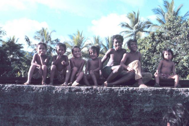 Micronesian children sitting on a railroad rail Picture