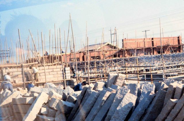 Human labor construction site with wood scaffolding Picture