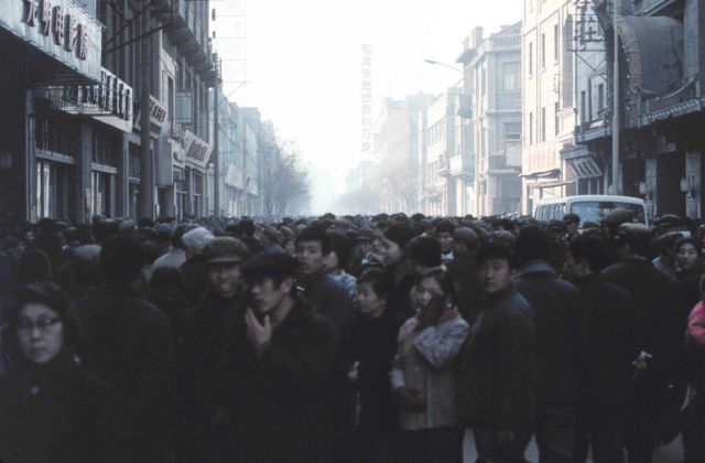 Mass of people crowding an urban street Picture