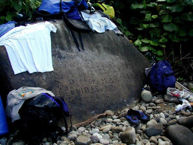 A historical boulder on the beach at Isla Cocos having carvings of names and dates of past visitors to the island Picture