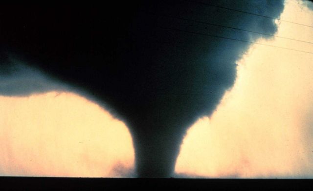 Horizontal cloud is ahead of tornado motion while near vertical cloud is behind. Picture