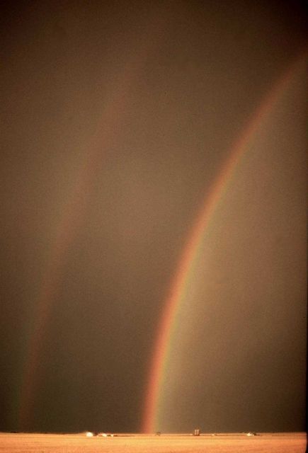 Rainbow with reflection over an Oklahoma wheatfield. Picture