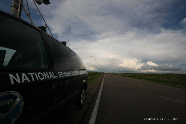 Mobile Mesonet vehicle stopped alongside the road with storm ahead. Picture