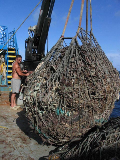 A big load of derelict net debris being loaded onto the deck of contract vessel CASITAS. Picture