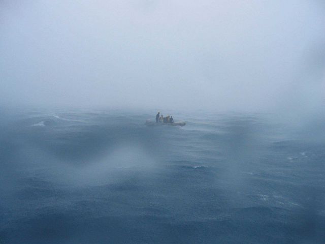 Inflatable boat waiting for retrieval by contract vessel CASITAS on a squally day. Picture