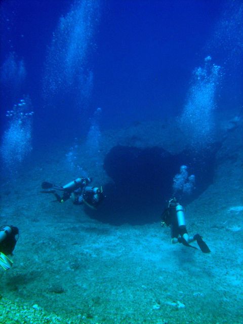 SCUBA divers approaching a sinkhole on a Guamanian reef. Picture
