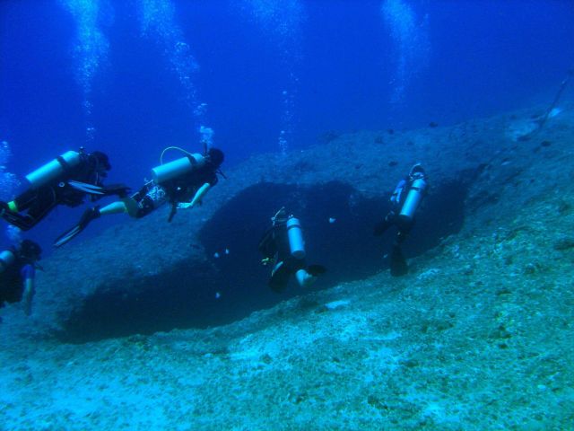 SCUBA divers approaching a sinkhole on a Guamanian reef. Picture