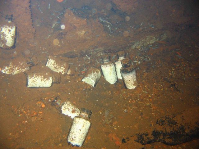 Medicine bottles strewn about the hold of the Fujikawa Maru. Picture