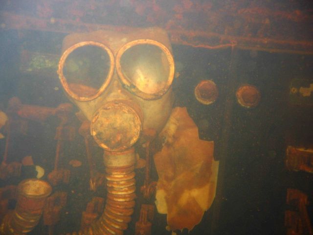 Gas mask staring at divers entering the engine room of the Fujikawa Maru. Picture