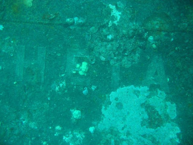 A portion of the Roman letters on the bow of the Heian Maru, a passenger vessel converted to a submarine tender. Picture