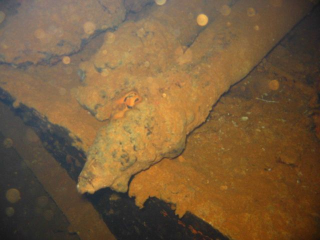Torpedoes strewn about the hold of the Heian Maru, a submarine tender. Picture