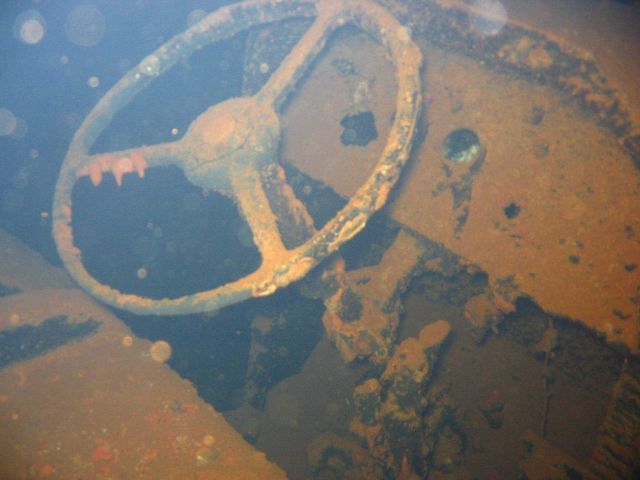 Cab and steering wheel of a truck on the Hoku Maru. Picture
