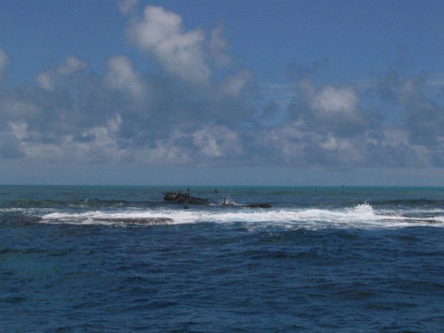 Debris from modern ship wreck on Pearl and Hermes Reef extending above surface. Picture
